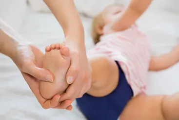 Osteópata tratando a un bebé con terapia manual pediátrica de forma suave y segura